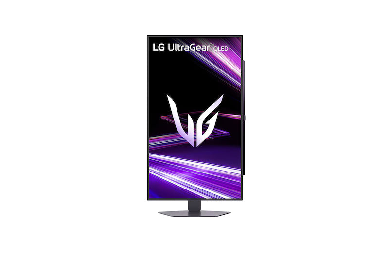 LG 27GX704A-B Monitor előlnézetben talpon, pivot módban elforgatva. A kijelzőn lilás absztrakt ábra és ultragear oled logó.