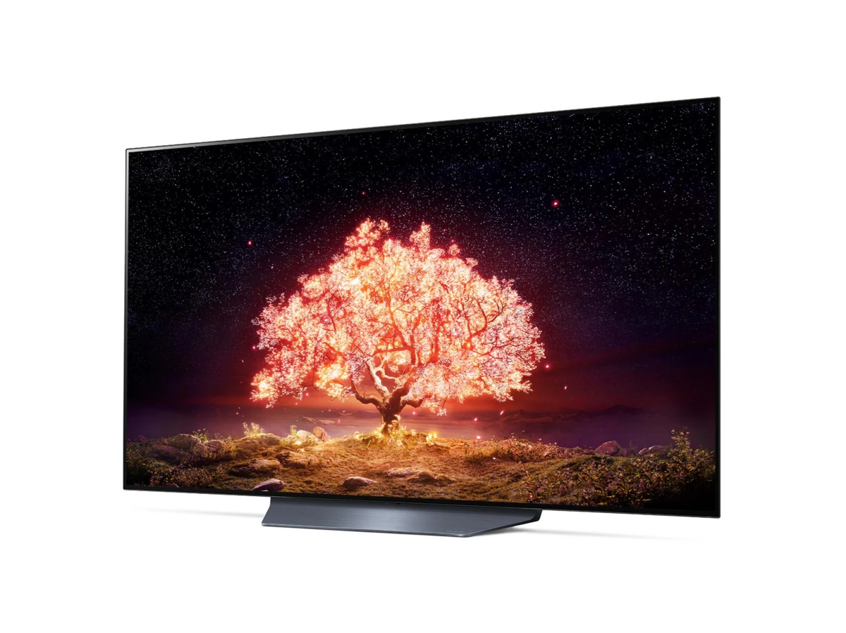 LG 55B1 OLED televízió előlnézetben enyhén balra fordítva talpon, a kijelzőn csillagos égbolt és narancssárgán világító fa.