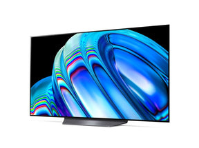 LG 55B2 OLED televízió előlnézetben enyhén balra fordítva talpon, a kijelzőn metál kék absztrakt ábra.