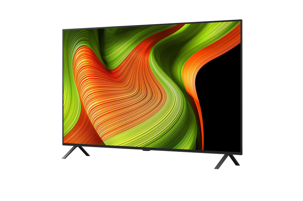 LG 83B5 OLED Televízió előlnézetben, talpon. A kijelzőn zöldés sárga absztrakt ábra.
