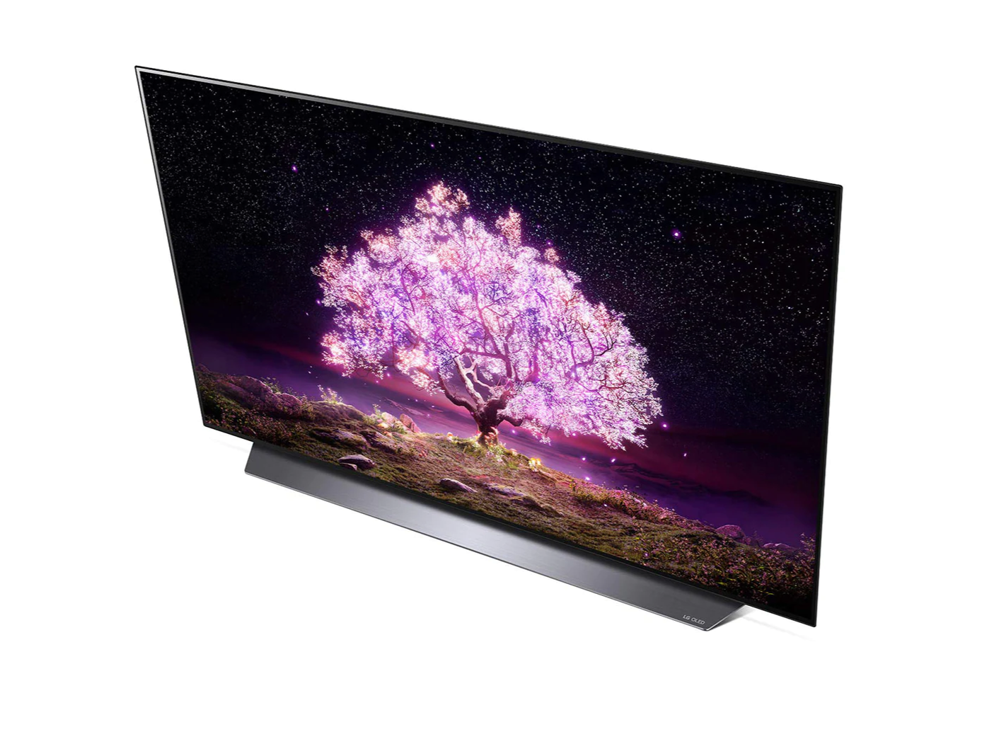 LG 83C1 OLED televízió fentről nézve talpon, a kijelzőn csillagos égbolt és rózsaszínben világító fa.