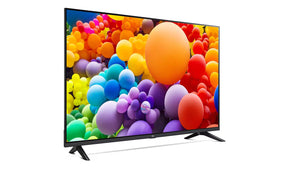 LG 65UT73003LA Smart televízió előlnézetben talpon, jobbra fordítva. A képernyőn élénk színes gömbök.